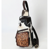 Black and white hide sling bag with tooled pouch