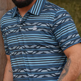 Close up view of the male model wearing the deep blue polo. 