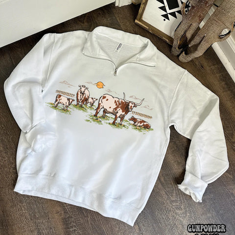 White quarter zip sweatshirt with color printed cattle drive scene on the front. 
