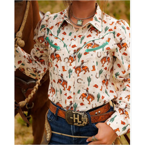 Front view of a cream colored shirt with bucking horse and western motiffs.