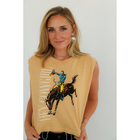 Model wearing the sleeveless ‘Hey Cowgirl’ bronco graphic top, front view showing the bold Western bucking bronco design, relaxed slightly cropped fit, and raw‑edge armholes.