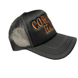 Side view of black mesh cap with 'COWBOY HAT' text in brown