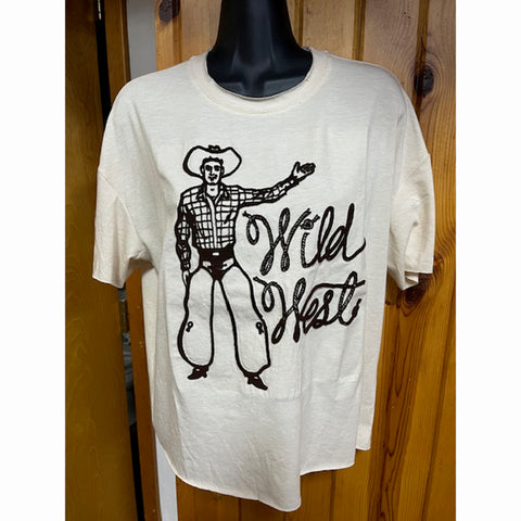 Cream crop t-shirt featuring a cowboy wearing chaps with the text 'Wild West' in a western scroll