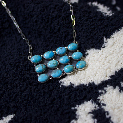 12 stone sterling silver and Kingman turquoise necklace. Shaped like  rectangle where stones are small ovals.