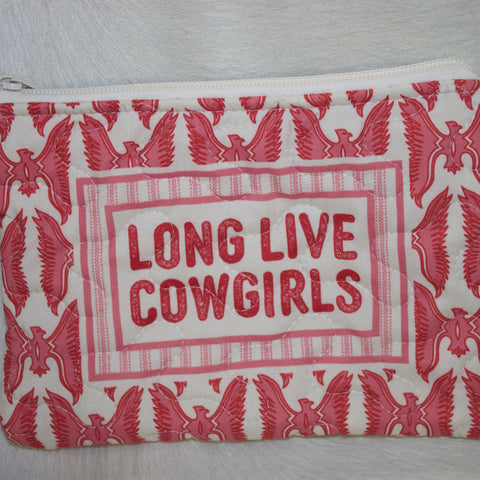Pink quilted zipper makeup bag with pink thunderbird printed fabric and "Long Live Cowgirls" written in the middle. White zipper is on the top of the bag.