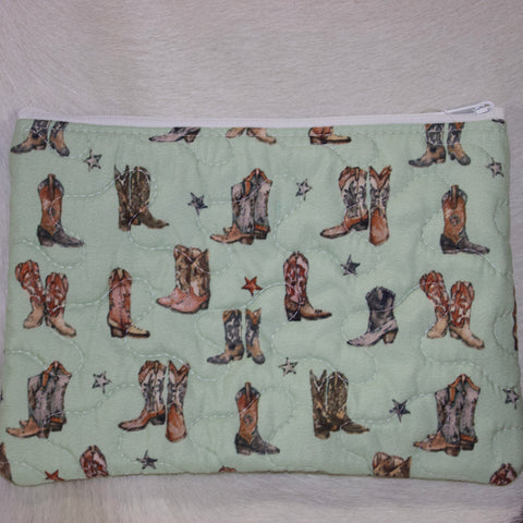 Sage green quilted makeup bag with retro cowboy boot designs and stars. 
