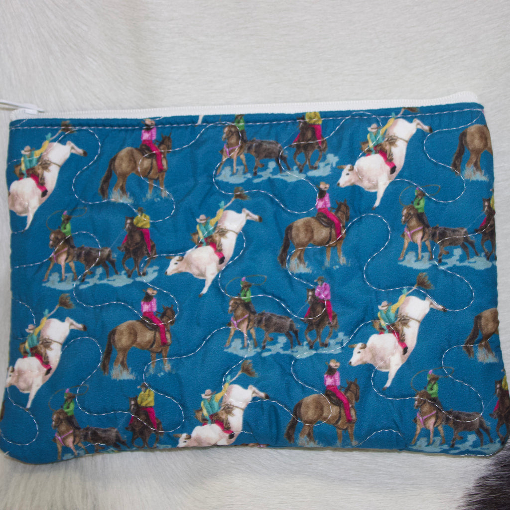 Small Dark blue quilted makeup bag with rodeo designs.