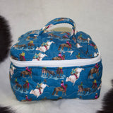 Dark blue quilted travel case with rodeo designs all over and a white zipper that goes around three sides and a handle on top.