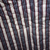 Inside lining of the bag, same red white and blue striped pattern as the straps.