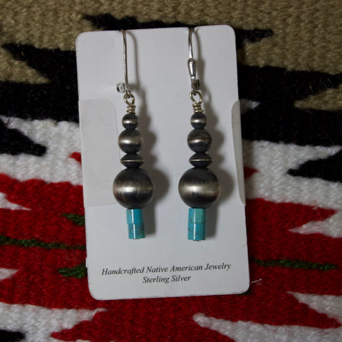 Graduated Navajo pearl earrings with hook attachment and 4 graduated Navajo pearls with one being a disc shape and two turquoise beads at the bottom.