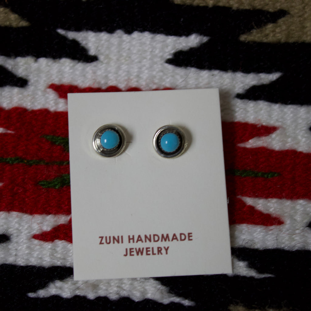 Small circle stud earrings with a small turquoise stone in the middle with silver border. 