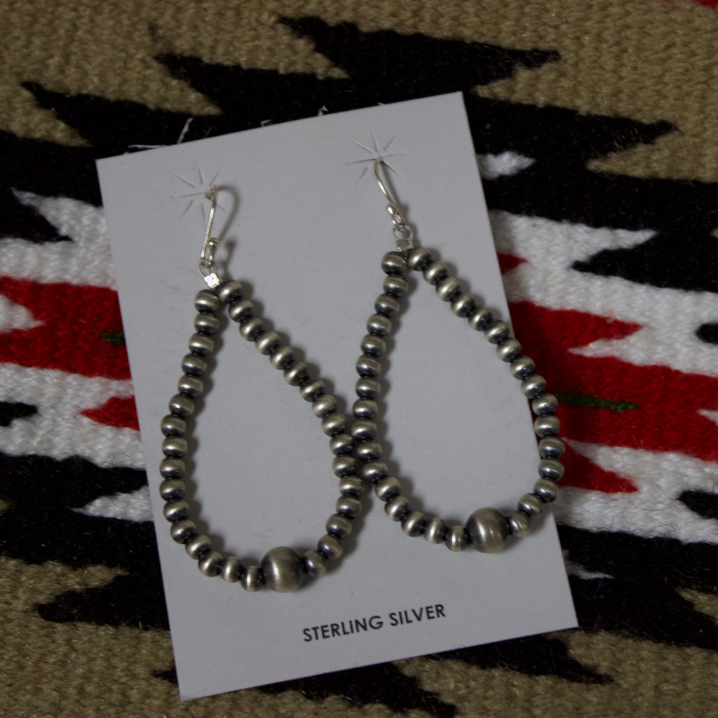 Navajo Pearl loop earrings with a big pearl on the bottom. 