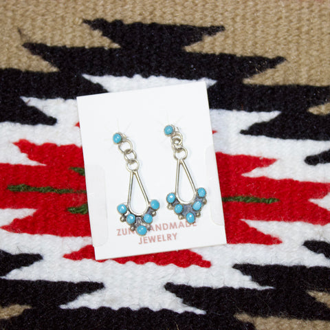 Sterling silver earrings with turquoise stone at the top, silver circle links, and then teardrop with five small turquoise stones on the bottom. 