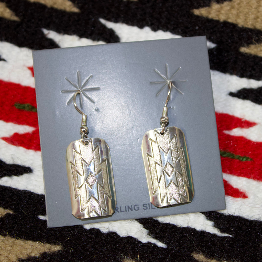 Sterling silver earrings with intricate Aztec designs stamped on the face of them. 
