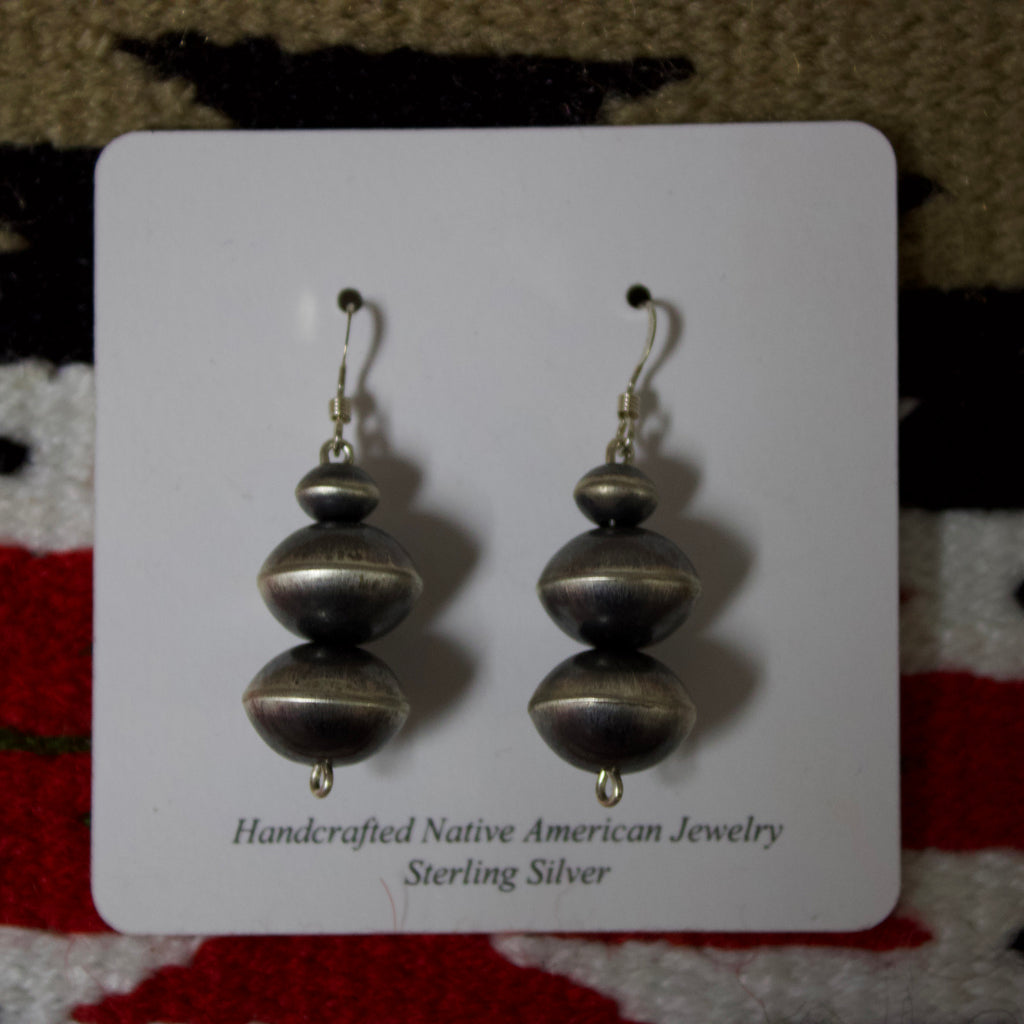 Navajo pearl earrings with three large Navajo pearls stacked on top of each other.