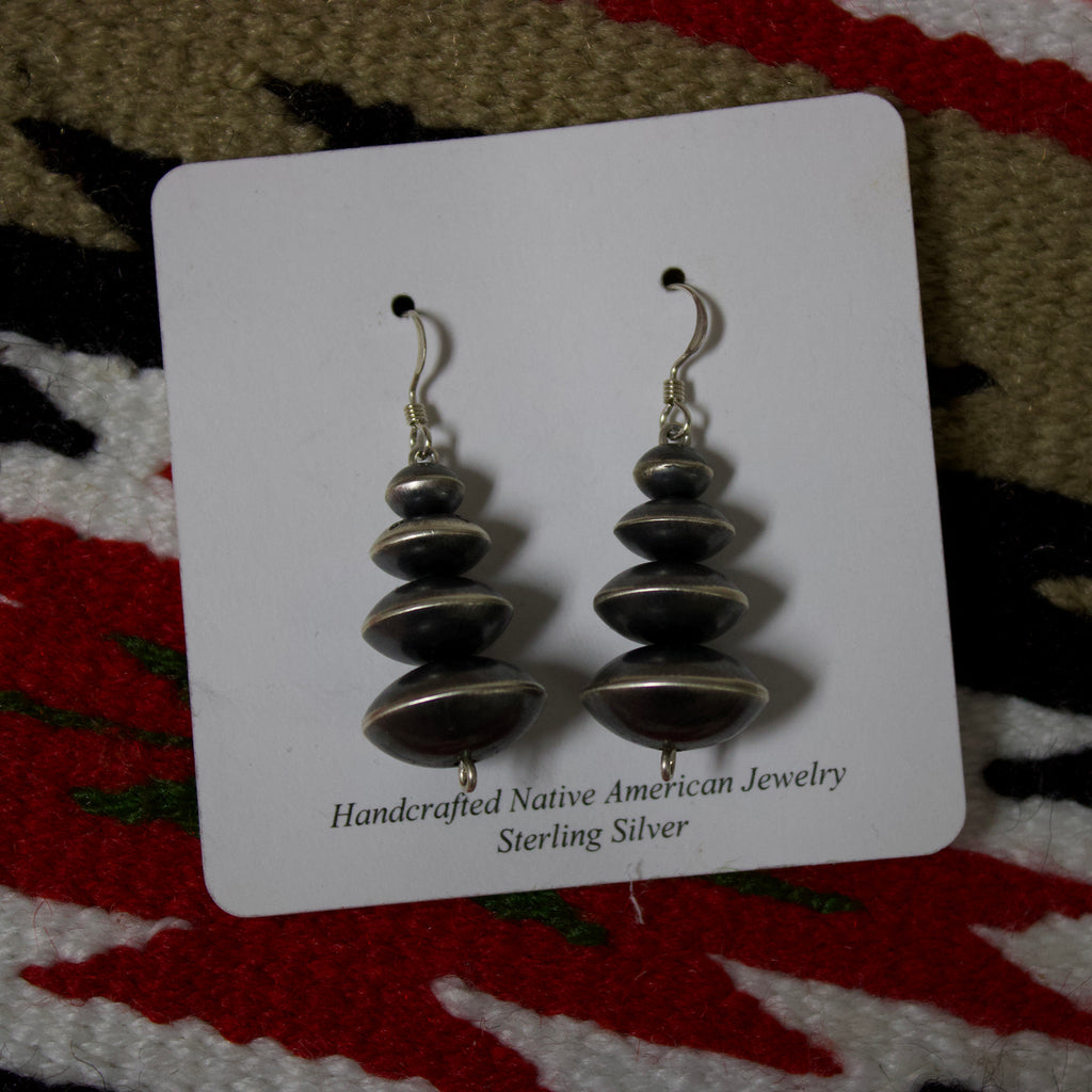 Navajo pearl earrings with four large disc shaped Navajo pearls that are graduated. 