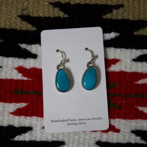 Small Sterling silver earrings with a teardrop shaped Kingman turquoise stone and a hook attachment. 