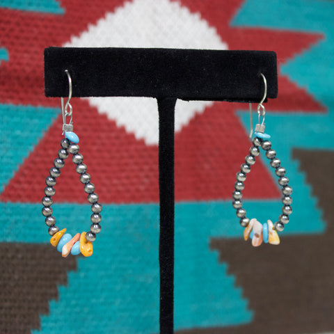 Navajo pearl teardrop loop earrings with turquoise and orange stones on the bottom. 