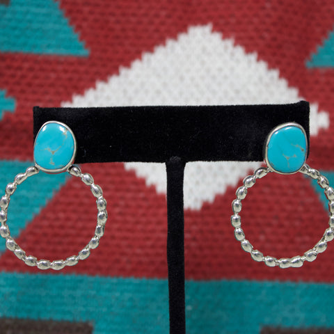Sterling silver hoop earrings with oval Kingman turquoise stone at the top. 