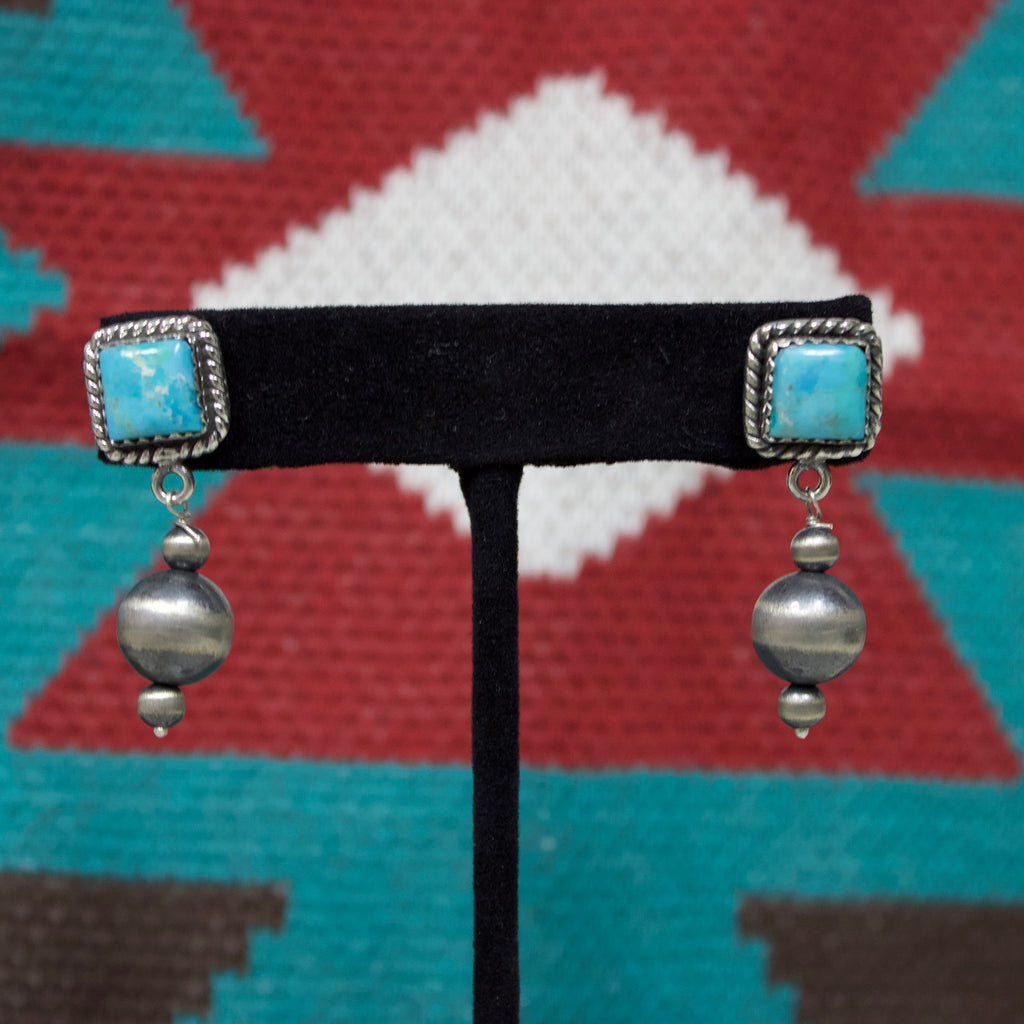 Square turquoise earrings with three Navajo pearls dangling below.
