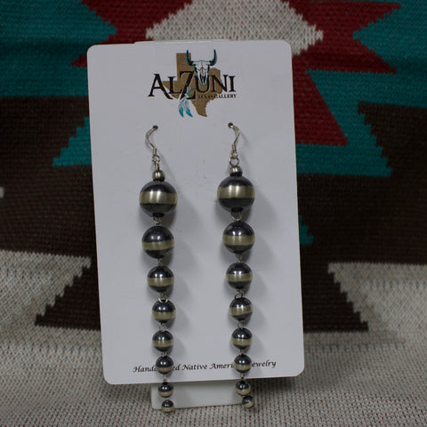 Navajo Pearl earrings that dangle down and gradually get smaller as they go down.