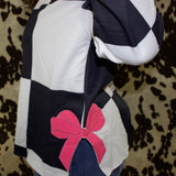 Side view of the long sleeve, the bottom on the sides there is a slit with a large pink bow at the top of the slit.