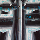 Close up view of the shirt, it has clear pearl snap buttons and blue stitching. 