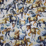 Close up view of the shirt design, shirt has blue pearl snap buttons and white stitching. 