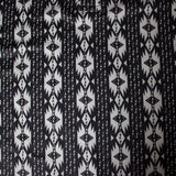 Close up view of the shirt design, shirt has three buttons at the top.  