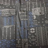 Close up view of the shirt print, shirt has silver pearl snaps and white stitching. 