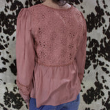 Back of the shirt, the lace detailing cover the top half of the shirt and shoulders of the sleeve are puffed. 