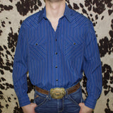 Dark blue long sleeve pearl snap shirt with blue vertical stripes.