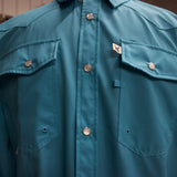 Close up view of the chest, pockets have one pearl snap each ad left pocket has a pen loop on the side.