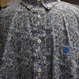 Close up View of the design on the shirt. Left pocket has a blue stitched logo.