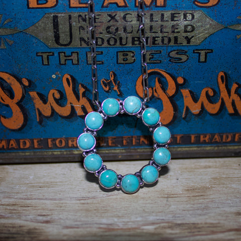 Sterling silver necklace with large circle of turquoise stones. 