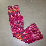 Pink, purple, and orange Aztec print flare pants. 