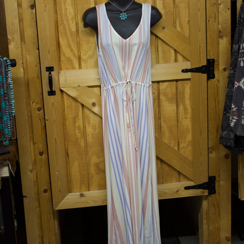 Pastel Red, blue, and yellow vertical striped dress. It is floor length and has an elastic tie around the waist. 