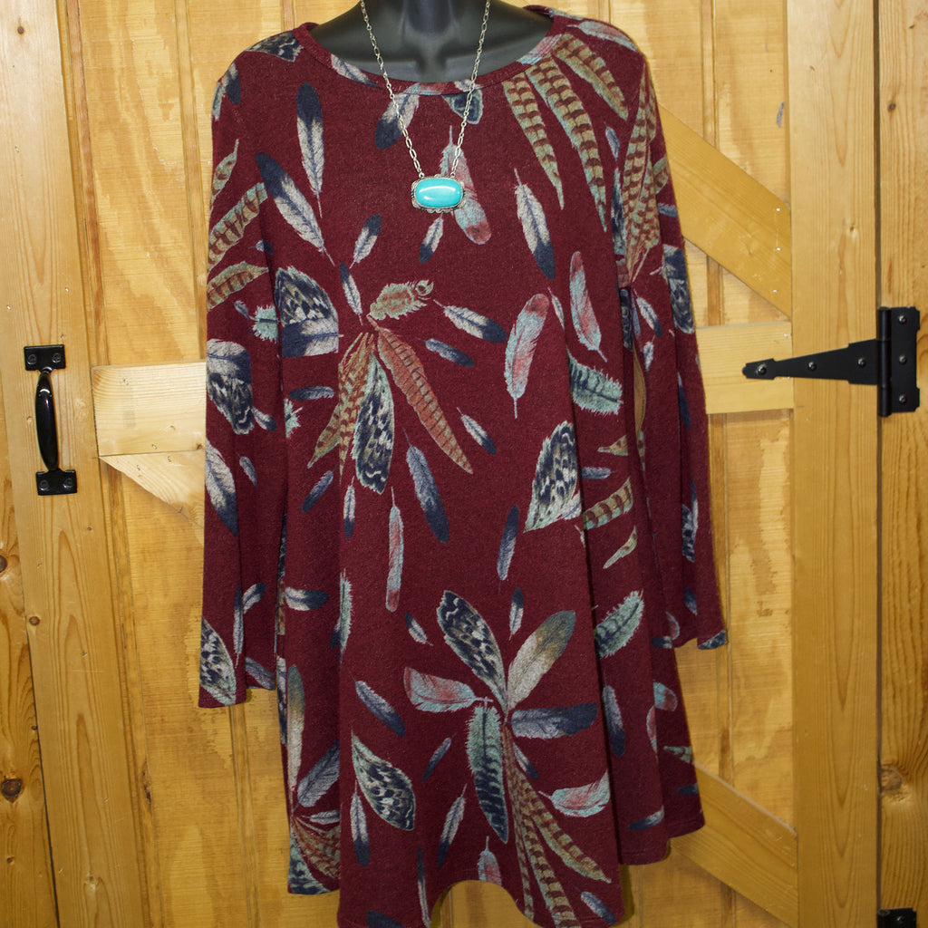 Burgundy colored long sleeve, above the knee length dress with feathers printed all over. 