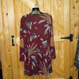 Back side view of the dress, elbows have brown suede patches. 