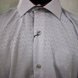 Close up view of the shirt, shirt has a subtle wavy design.