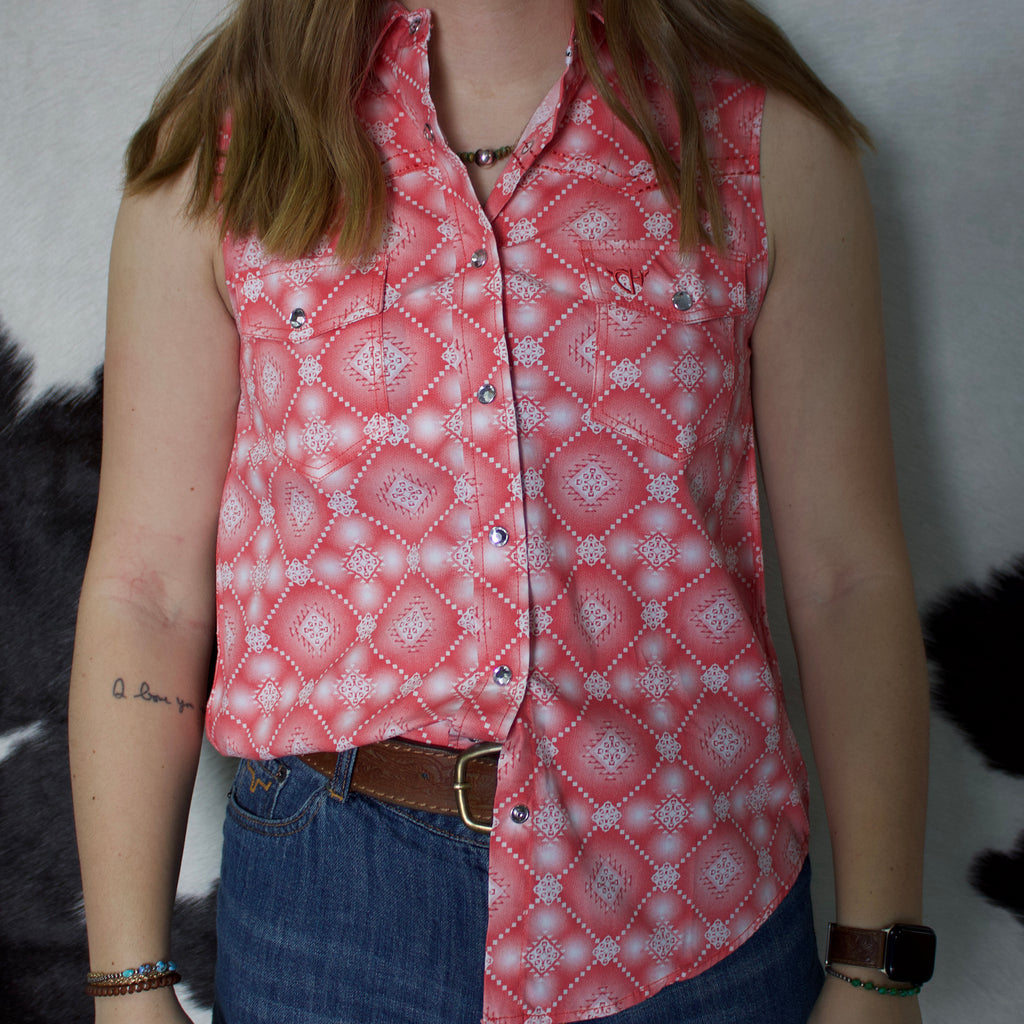 Coral and white Aztec printed sleeveless shirt with snap closure and spread collar. 