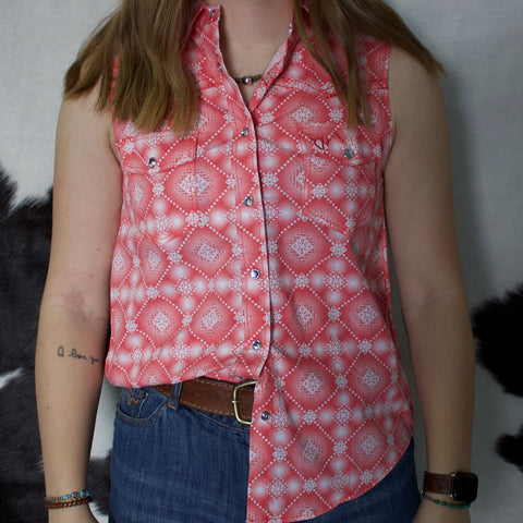 Coral and white Aztec printed sleeveless shirt with snap closure and spread collar. 