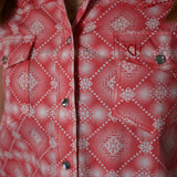 Close up view of the front of the shirt, buttons are diamonds and it has two chest pockets with flap snap closures. 