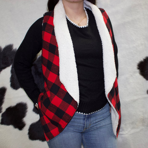 Model front facing wearing the vest open. 