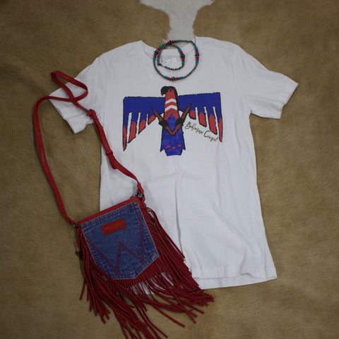 Fla lay view of white, red. and blue t shirt with necklace and purse laying next to it. 