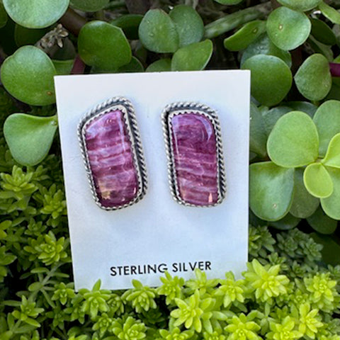 Sterling silver, Purple Spiny Oyster earrings  on a white card, surrounded by green plants.