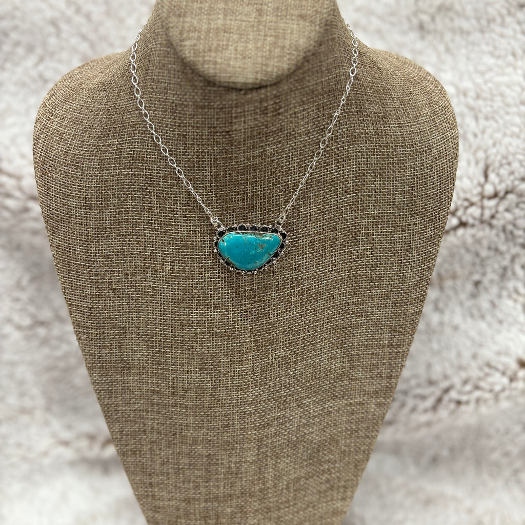 Large thunder MT turquoise stone with sterling silver chain and sterling silver embellishments around the stone 