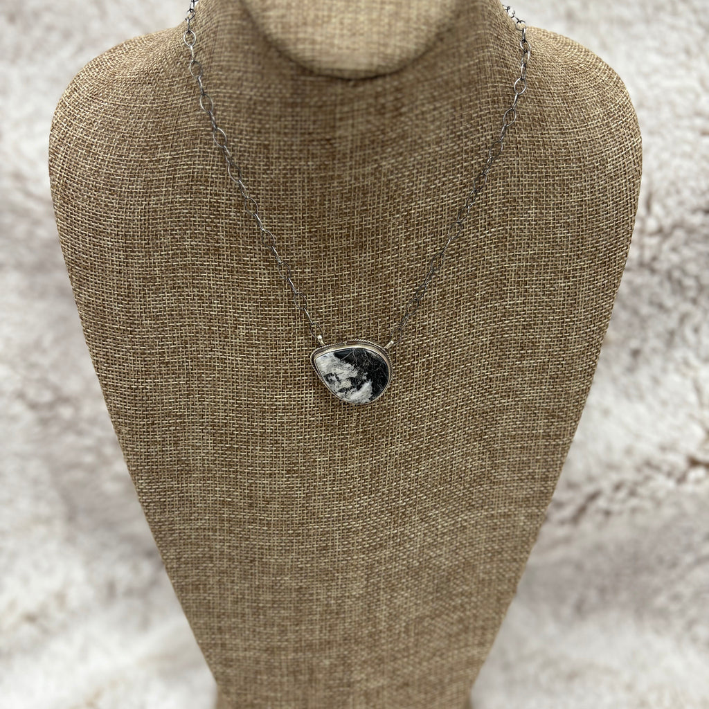 Medium sized white buffalo stone in a teardrop shape turned sideways