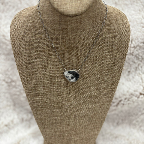 Medium sized white buffalo stone in a teardrop shape turned sideways
