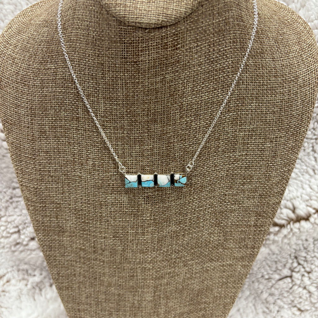 Sterling Silver bar necklace with 4 small square blue and white cotton candy stones 